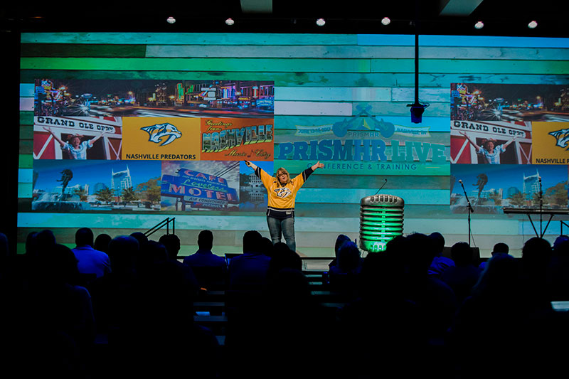 Brenda Rowan speaking to PrismHR Crowd from stage
